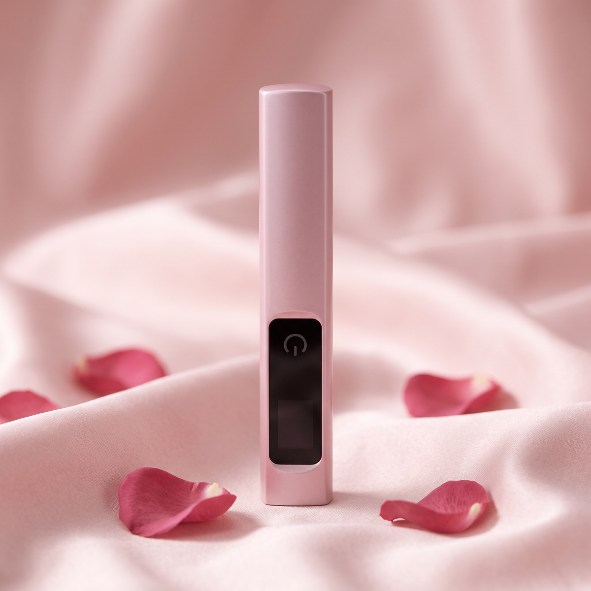 Pink handheld LED nail lamp on blush silk with rose petals