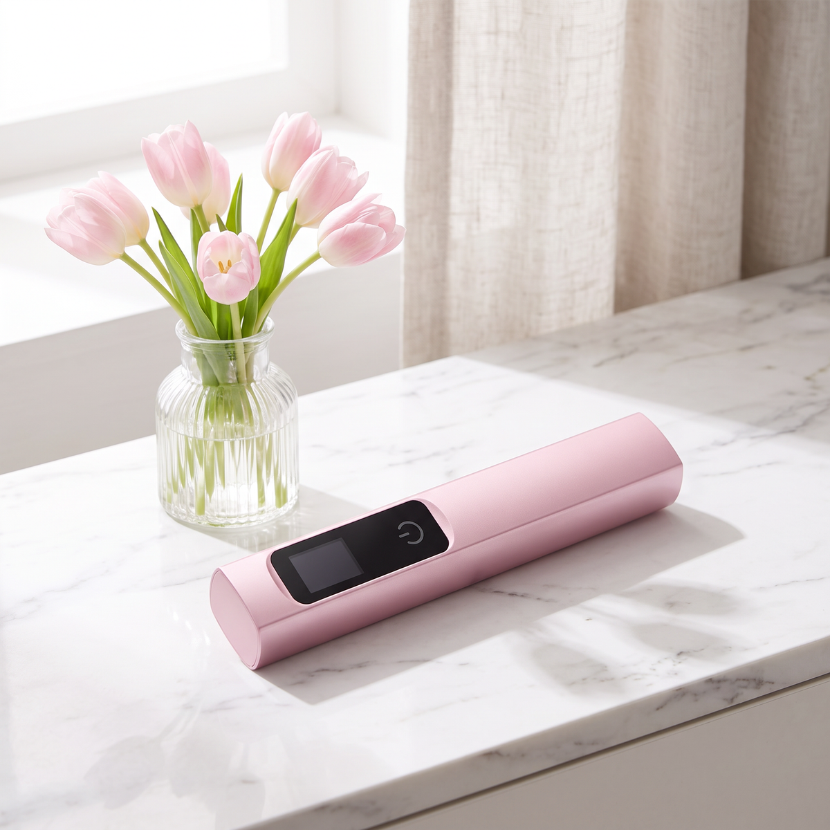 Pink handheld LED nail lamp on marble with pink tulips